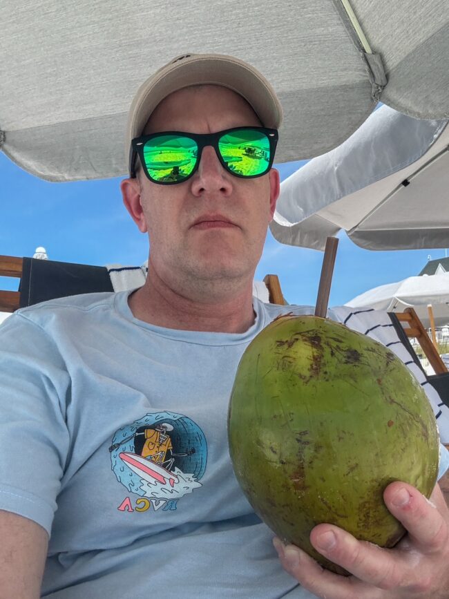 5 Moments of Peace I Found at Henderson Beach Resort 3 a man holding a coconut